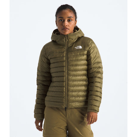 Person wearing a green puffer jacket with a brand logo on a white background - The North Face Terra Peak Hooded Jacket (Women's) - Cedar