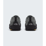 A pair of The North Face low-top sneakers shown from the back, featuring a dark gray and black colorway with a small orange logo accent on the outsole. - The North Face Verto Approach Shoes (Unisex) - Smoked Pearl/TNF Black