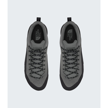 A pair of gray and black low-top sneakers shown from a top-down view on a light gray background. The shoes feature gray suede and mesh uppers with black laces, black soles, and the 'The North Face' logo printed on the tongue. - The North Face Verto Approach Shoes (Unisex) - Smoked Pearl/TNF Black