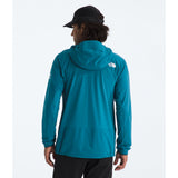 A person shown from the back wearing a teal hooded jacket with a small white The North Face logo on the left shoulder, a black cap, and black pants, against a clean white studio background. - The North Face Summit Series Off Width Jacket (Men's) - Dusk Blue