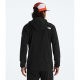 Person wearing a black hoodie with a logo on the back, standing against a white background - The North Face Summit Series Off Width Jacket (Men's) - TNF Black