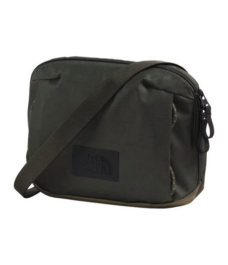The North Face dark olive green nylon shoulder bag with a black brand patch on the front, set against a plain white background. - The North Face Base Camp Voyager Pro Crossbody Bag - New Taupe Green/TNF Black