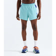 A model from the waist down wearing light blue athletic shorts with dark blue side accents, white crew socks, and blue running shoes with orange laces, set against a plain white studio background. - The North Face Summit Series Pacesetter 5" Run Shorts-Graphic (Men's) - Canal Blue