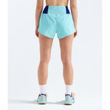 A person shown from the back wearing light aqua athletic shorts with dark navy side panels, white socks, and matching light aqua running shoes against a clean white studio background. - The North Face Summit Pacesetter Short-Graphic (Women's) - Canal Blue