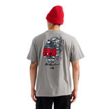 Person wearing a gray t-shirt with a robot graphic on the back, standing against a white background. - The North Face Gear Up Get Out Relaxed Short-Sleeve Tee-Graphic (Unisex) - Stone Slab