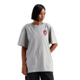 Person wearing a gray t-shirt with a logo on a white background - The North Face Gear Up Get Out Relaxed Short-Sleeve Tee-Graphic (Unisex) - Stone Slab
