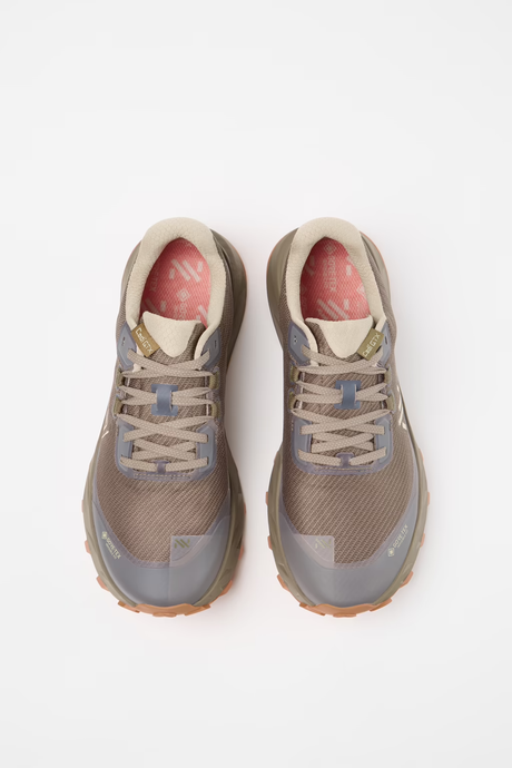 A pair of trail running shoes in a muted taupe and gray colorway, featuring a mesh upper, lace-up closure, and a pink interior lining, shown from a top-down view on a white background. - NNormal Cadí GORE-TEX Shoes (Men's) - Brown