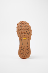 Close-up of a brown shoe sole with tread pattern on a white background - NNormal Cadí GORE-TEX Shoes (Men's) - Brown