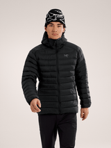 Person wearing a black puffer jacket and patterned beanie on a light gray background - Arc'teryx Cerium Hoody (Men's) - Black