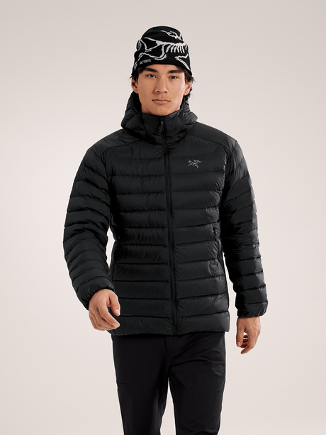 Person wearing a black puffer jacket and patterned beanie on a light gray background - Arc'teryx Cerium Hoody (Men's) - Black