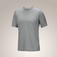 A light gray short-sleeve athletic t-shirt with subtle shoulder panel detailing, shown on a neutral beige gradient background. - Arc'teryx Merino Wool Shirt Short Sleeve (Men's) - Void