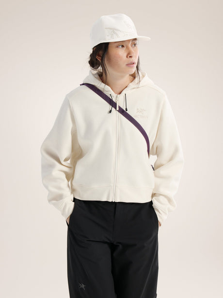 Person wearing a white hoodie with a purple zipper and black pants on a light background - Arc'teryx Mantis 2 Waist Pack - Moondrop