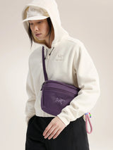 Person wearing a white hoodie with a purple bag over their shoulder on a plain background - Arc'teryx Mantis 2 Waist Pack - Moondrop