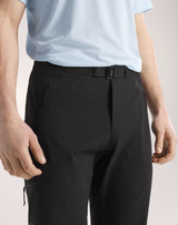 Close-up of a person wearing black technical pants with a matching black belt, paired with a light blue t-shirt, against a neutral studio background. - Arc'teryx Gamma SL Pants (Men's) - Black