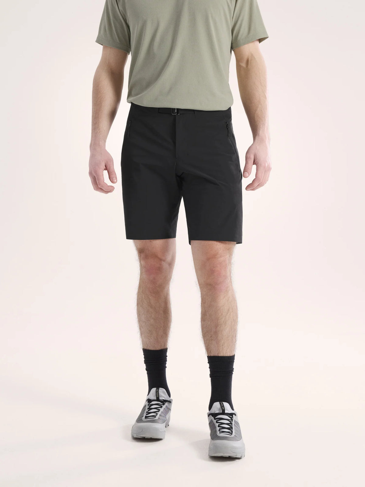 Person wearing black shorts and a green shirt on a light background - Arc'teryx Gamma SL Shorts 9" (Men's) - Black