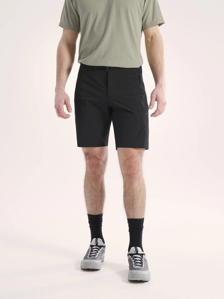 Person wearing black shorts and a green shirt on a light background - Arc'teryx Gamma SL Shorts 9" (Men's) - Black
