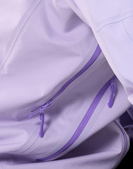 Close-up of a light lavender jacket with matching purple zipper pulls and a darker purple zipper track. - Arc'teryx Beta AR GORE-TEX Jacket (Women's) - Mallow