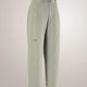 A pair of light sage green cropped trousers with a small embroidered Arc'teryx logo on the left thigh, displayed on a neutral light gray background. - Arc'teryx Nia Pants (Women's) - Habitat