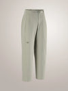A pair of light sage green cropped trousers with a small embroidered Arc'teryx logo on the left thigh, displayed on a neutral light gray background. - Arc'teryx Nia Pants (Women's) - Habitat