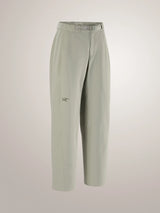 A pair of light sage green cropped trousers with a small embroidered Arc'teryx logo on the left thigh, displayed on a neutral light gray background. - Arc'teryx Nia Pants (Women's) - Habitat