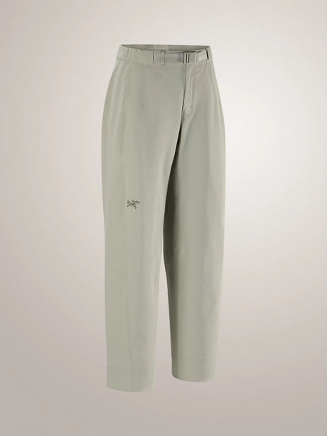 A pair of light sage green cropped trousers with a small embroidered Arc'teryx logo on the left thigh, displayed on a neutral light gray background. - Arc'teryx Nia Pants (Women's) - Habitat