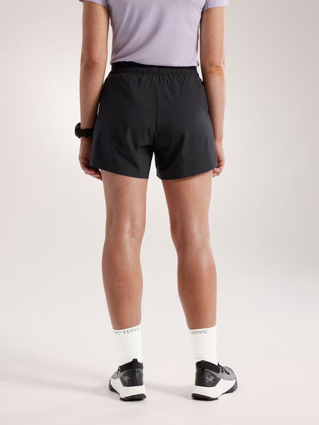 Person wearing black athletic shorts on a plain background - Arc'teryx Norvan Shorts 5" 2-in-1 (Women's) - Black
