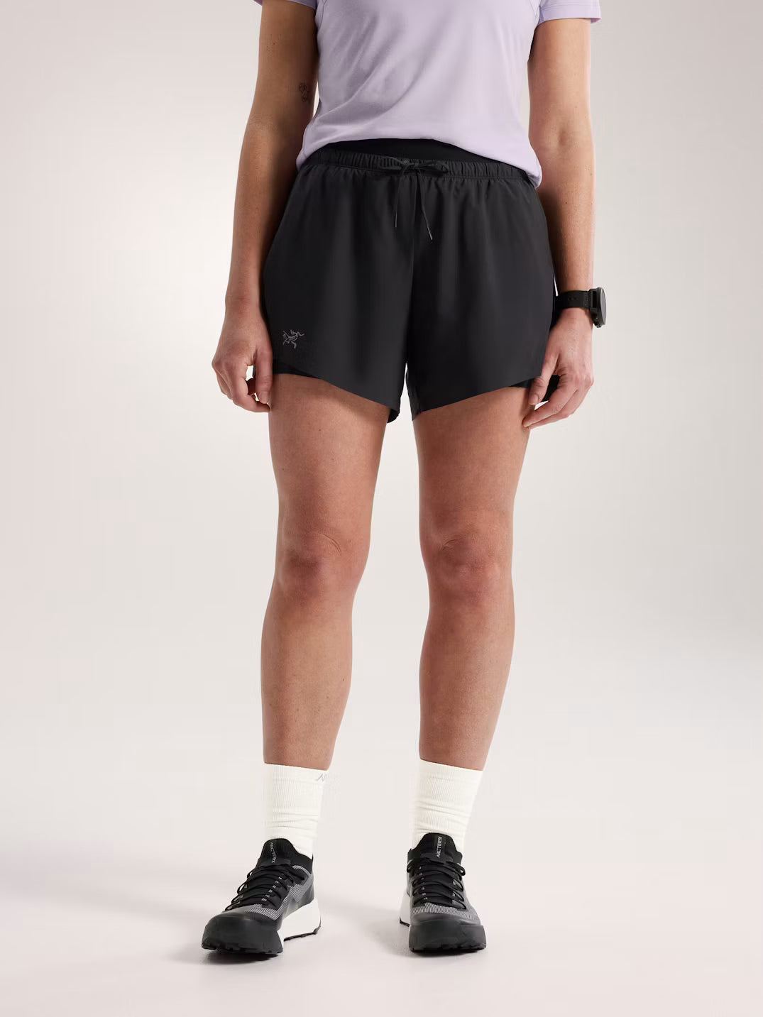Person wearing black athletic shorts on a plain background - Arc'teryx Norvan Shorts 5" 2-in-1 (Women's) - Black