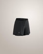 Black athletic shorts with a drawstring waist and a small Arc'teryx logo near the hem, shown against a light beige studio background. - Arc'teryx Norvan Shorts 5" 2-in-1 (Women's) - Black