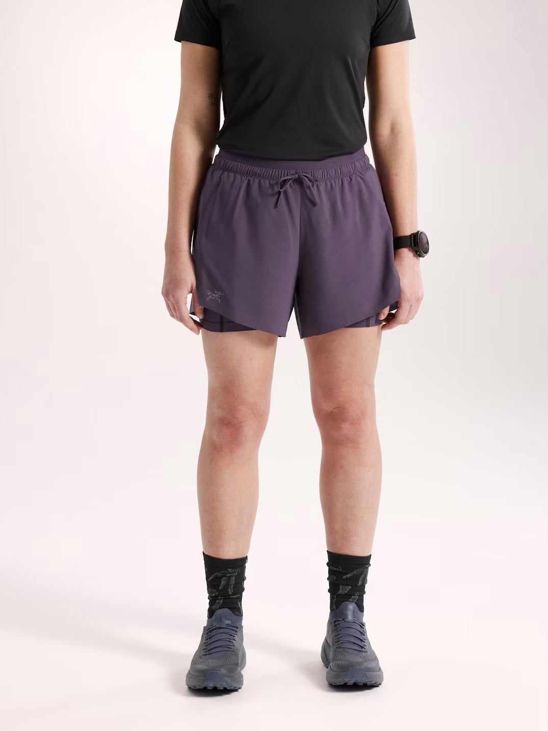 Person wearing purple athletic shorts on a white background - Arc'teryx Norvan Shorts 5" 2-in-1 (Women's) - Moondrop