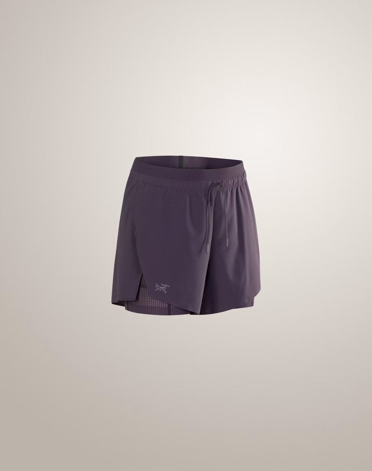 A pair of Arc'teryx running shorts in a muted purple shade, shown against a plain light beige studio background. - Arc'teryx Norvan Shorts 5" 2-in-1 (Women's) - Moondrop