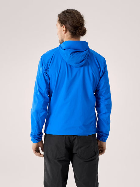 Person wearing a blue jacket on a plain background - Arc'teryx Squamish Hoody (Men's) - Fluidity
