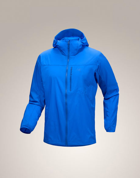 A bright blue hooded zip-up jacket displayed on a neutral beige gradient background. - Arc'teryx Squamish Hoody (Men's) - Fluidity