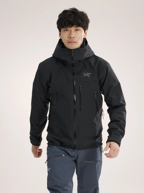 Person wearing a black jacket with a brand logo on a light gray background - Arc'teryx Beta SV Jacket (Men's) - Black