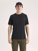Man wearing a black t-shirt and cap on a light pink background - Arc'teryx Cormac Crew Neck Shirt Short Sleeve (Men's) - Black