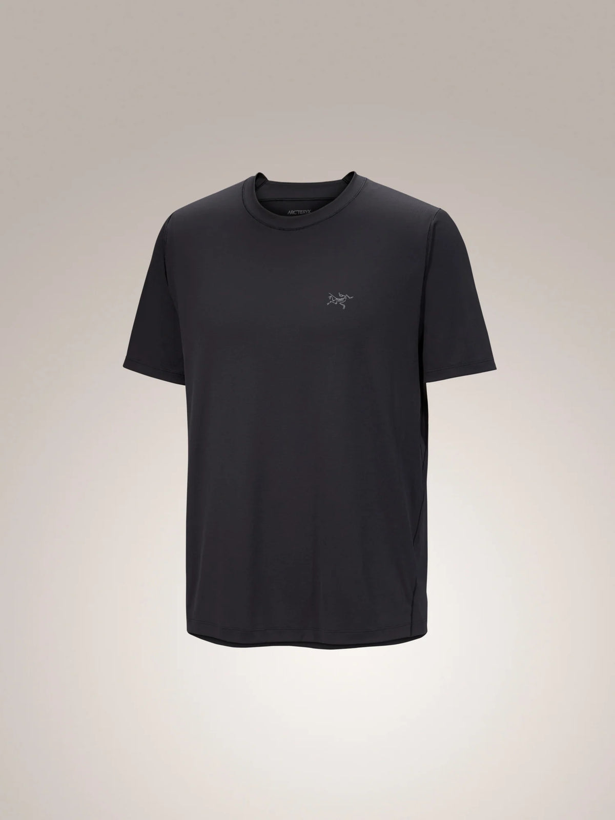 A black short-sleeve crewneck t-shirt with a small gray embroidered Arc'teryx logo on the left chest, displayed against a neutral light gray gradient background. - Arc'teryx Cormac Crew Neck Shirt Short Sleeve (Men's) - Black
