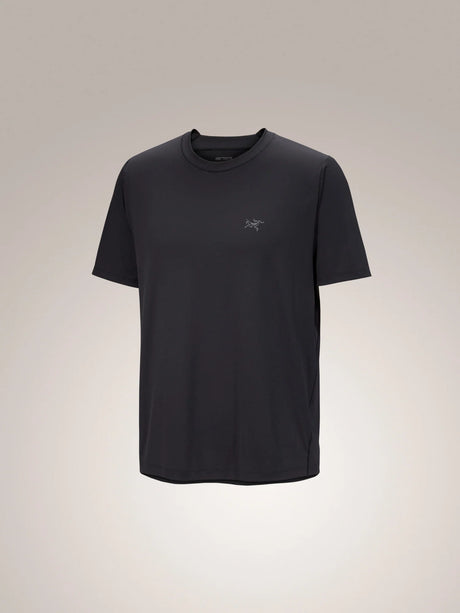 A black short-sleeve crewneck t-shirt with a small gray embroidered Arc'teryx logo on the left chest, displayed against a neutral light gray gradient background. - Arc'teryx Cormac Crew Neck Shirt Short Sleeve (Men's) - Black
