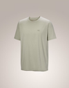 A light sage green short-sleeve crewneck t-shirt with a small embroidered Arc'teryx logo on the left chest, displayed against a neutral beige gradient background. - Arc'teryx Cormac Crew Neck Shirt Short Sleeve (Men's) - Habitat