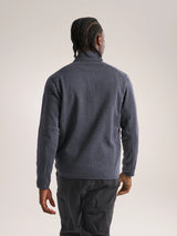 Person wearing a gray fleece jacket and pants on a plain background - Arc'teryx Covert Cardigan (Men's) - Dark Stratus Healther/Black Sapphire