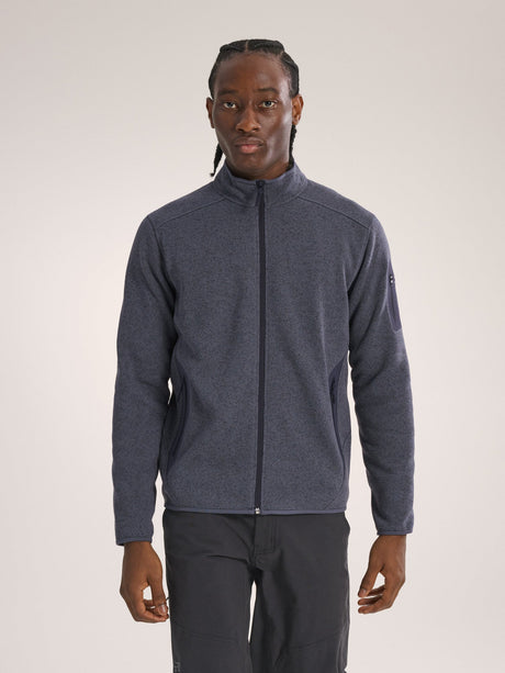 Man wearing a gray fleece jacket on a plain background - Arc'teryx Covert Cardigan (Men's) - Dark Stratus Healther/Black Sapphire
