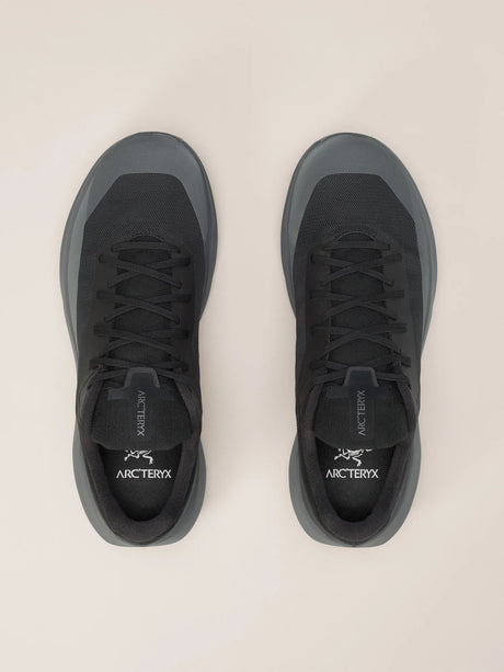 A pair of Arc'teryx low-top sneakers in dark gray and black, shown from a top-down view on a light beige background. - Arc'teryx Norvan LD 4 Shoes (Women's) - Black/Graphite