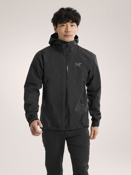 Person wearing a black jacket with a brand logo on a light gray background - Arc'teryx Beta Jacket (Men's) - Black