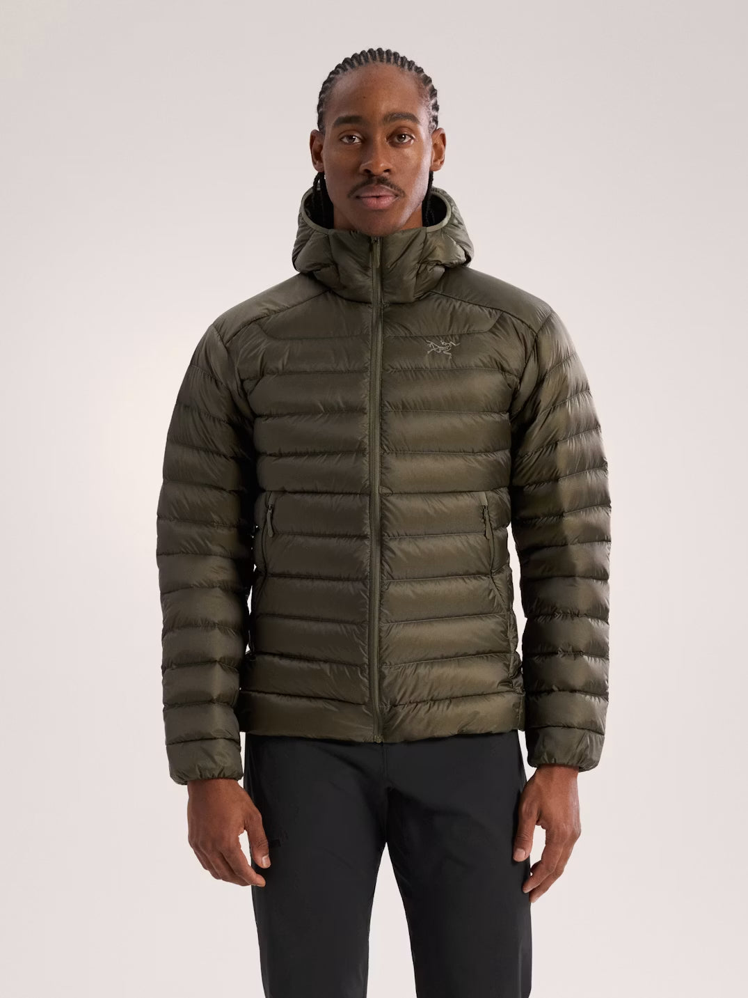 Person wearing a green puffer jacket on a plain background - Arc'teryx Cerium Hoody (Men's) - Tatsu II