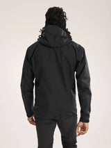 Person wearing a black hooded jacket on a light gray background - Arc'teryx Beta SL Jacket (Men's) - Black