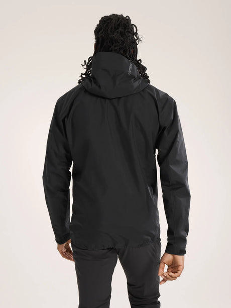 Person wearing a black hooded jacket on a light gray background - Arc'teryx Beta SL Jacket (Men's) - Black