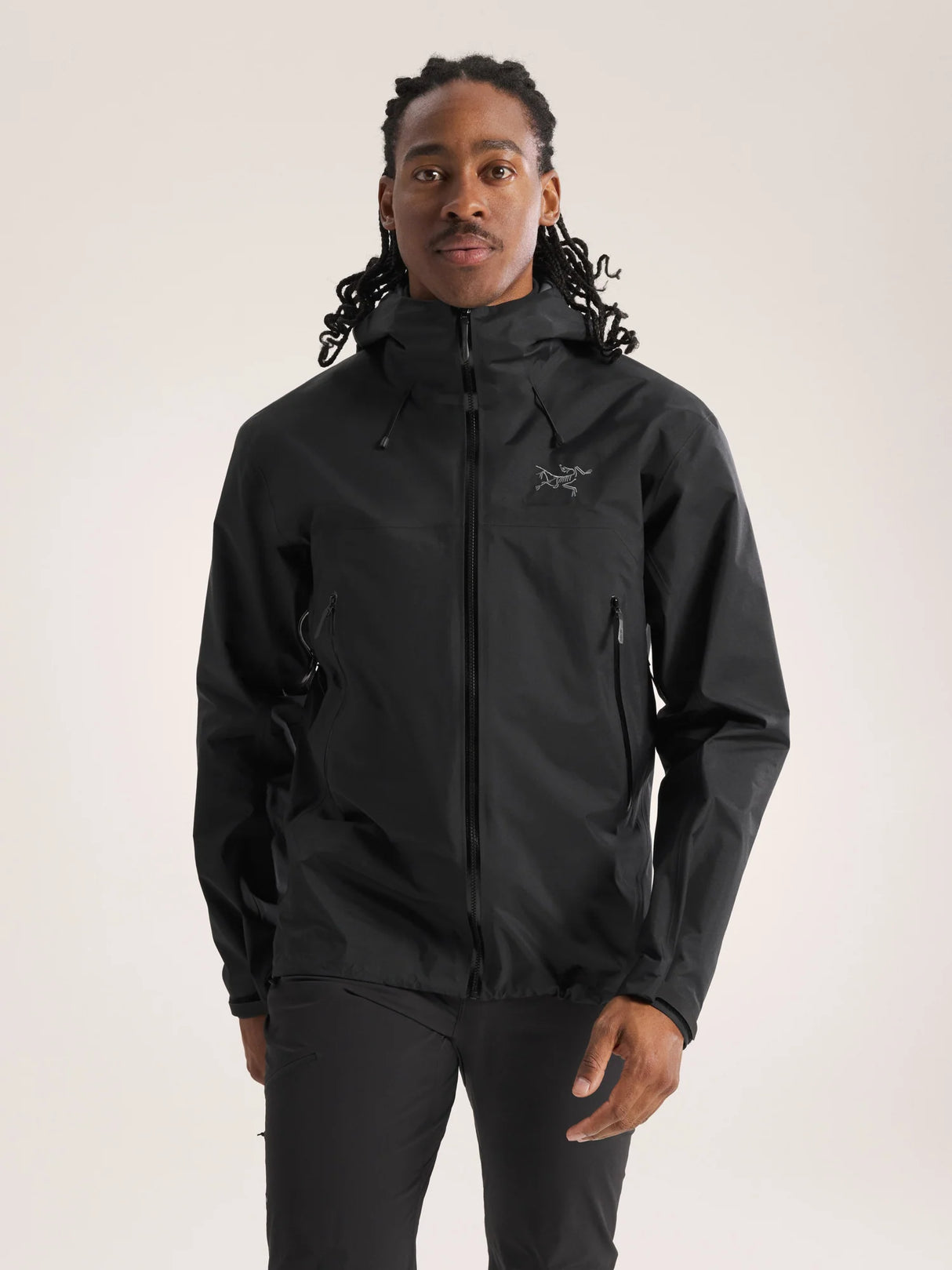 Person wearing a black jacket with a brand logo on a light gray background - Arc'teryx Beta SL Jacket (Men's) - Black