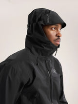 Person wearing a black jacket with a hood on a light gray background - Arc'teryx Beta SL Jacket (Men's) - Black