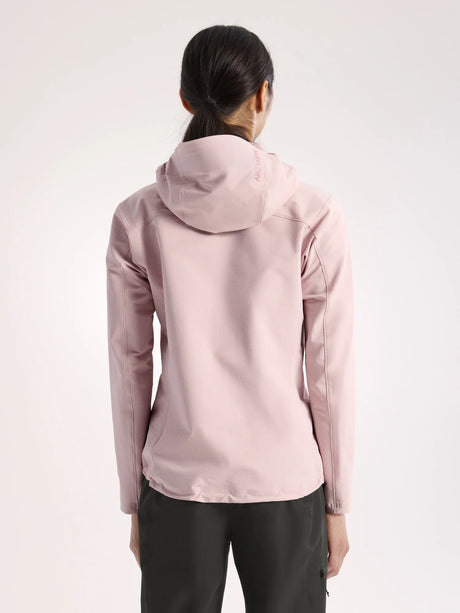 A woman viewed from the back wearing a light pink hooded jacket and dark pants against a plain light background. - Arc'teryx Gamma Hoody (Women's) - Alpine Rose
