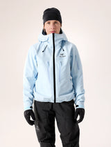 Person wearing a light blue jacket with a brand logo on a plain background - Arc'teryx Alpha SV Jacket (Women's) - Alpine Blue/Black