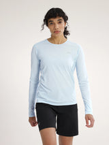 Person wearing a light blue long-sleeve shirt and black shorts on a white background - Arc'teryx Sunna Crew Shirt Long Sleeve (Women's) - Alpine Blue