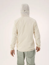 A person shown from the back wearing a light cream hooded jacket and light sage green pants against a plain light background. - Arc'teryx Squamish Hoody (Men's) - Sea Salt